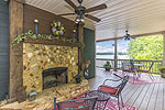 Stone fireplace on wrap around porch at 1691 Andrews Mill Road, Tallassee, AL-Lake Martin ALWaterfront homes for sale. Professional photos and tour by Go2REasssistant.com