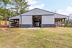 Large barn with stalls plus feed/tack room 984 Muskgokee Trail, Tallassee, AL. Professional photos and tour by Go2REasssistant.com
